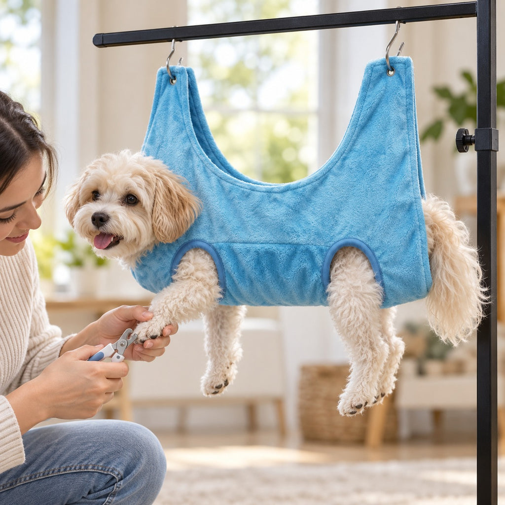 Dog resting in blue grooming hammock while owner trims its nails